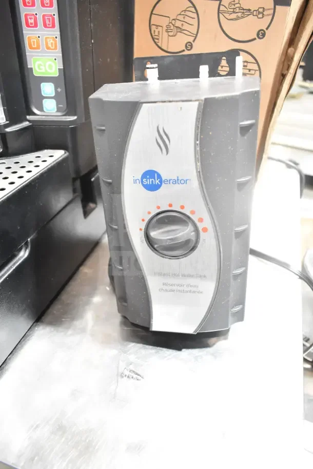 InSinkErator HWT Instant Hot Water Tank in original packaging, featuring adjustable temperature control and sleek design.