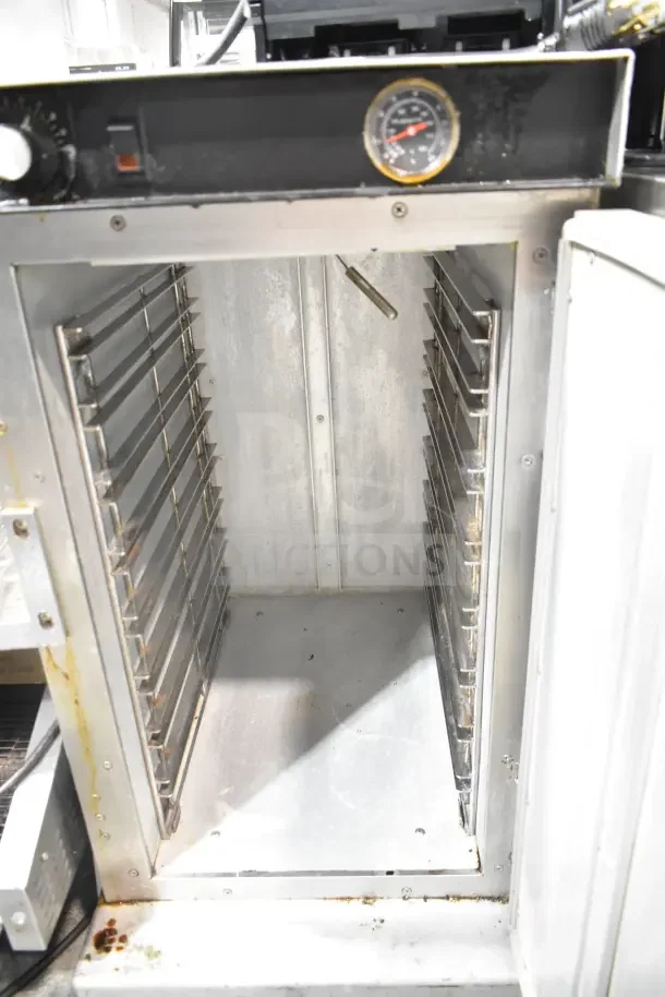 CresCor H33S128C heated holding cabinet with racks, visible thermometer, on casters. 120 volts, 1 phase. Used condition.