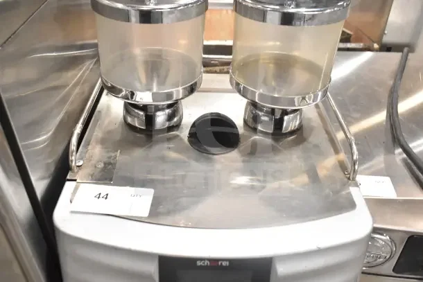 Schaerer SCA1 Coffee Art automatic espresso machine with dual hoppers, stainless finish, 208-240V, 1 phase, lot tag visible.