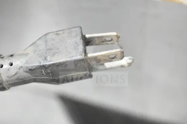Close-up of a worn electrical plug for a Thunderbird ARM-02 dough mixer. Plug shows signs of wear and corrosion.
