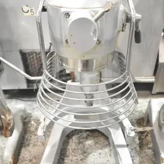 M20A Commercial 20L countertop planetary dough mixer with bowl guard, 110V, 1 phase. Visible wear and sturdy construction.
