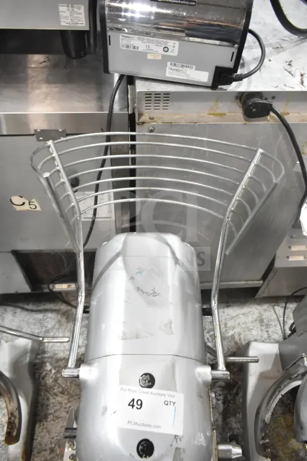 M20A 20L commercial countertop planetary dough mixer with bowl guard, 110V, 1 phase, visible product labels, and auction tag.