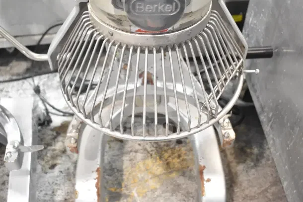 Berkel PM-2B 20-quart planetary dough mixer with bowl guard, showing visible wear. Model and branding on top.
