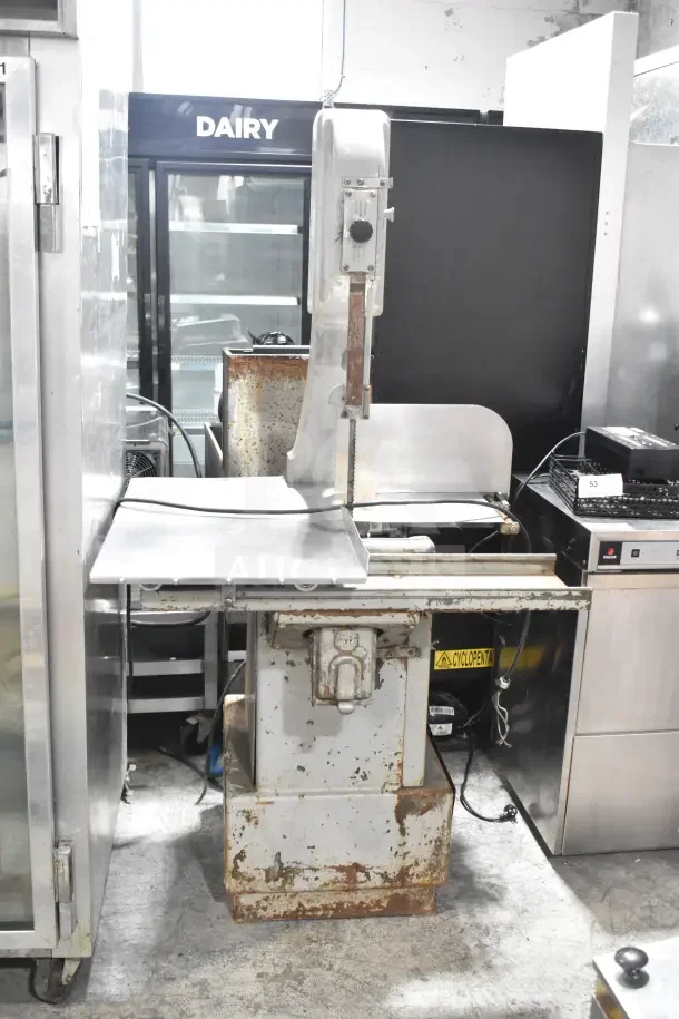 Butcher Boy B14 commercial meat saw, floor model, 220 volts, 1 phase, visible wear and rust, sturdy build.