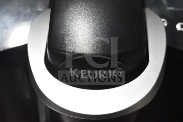 Keurig K40 Single Cup Coffee Machine, black with silver accents. Includes pod holder. Good condition. Visible Keurig logo.