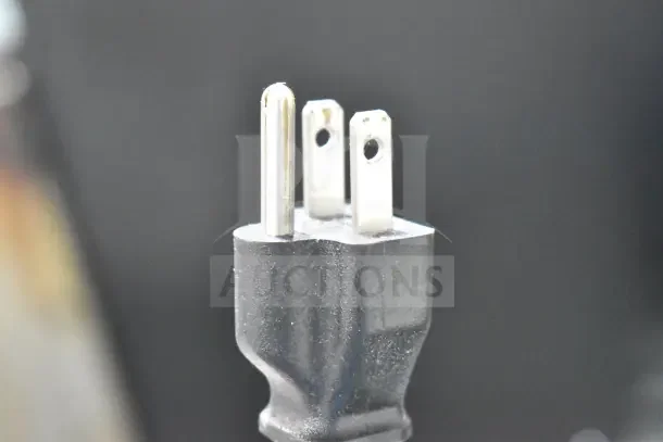 Close-up of a power plug for a Keurig K40 Single Cup Coffee Machine and Pod Holder. Bidding item for auction.