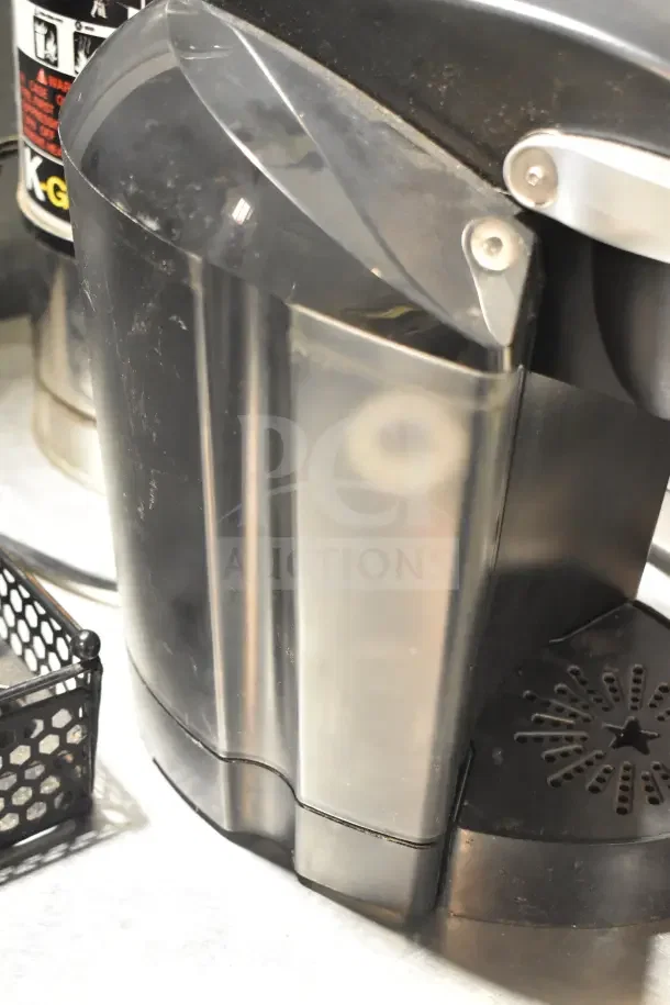 Keurig K40 single cup coffee machine and pod holder, black, used condition with some surface wear.