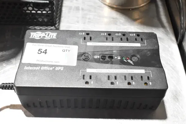 Tripp Lite Internet Office UPS with multiple outlets, surge protection, network ports, and indicator lights. Auction label 54.