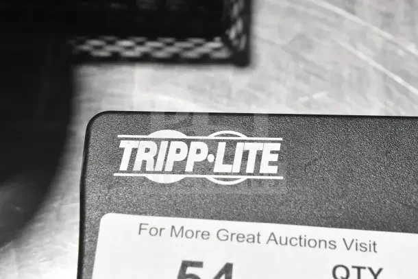Tripp Lite Uninterruptible Power Supply, close-up of logo on black casing, showing item label for auction.