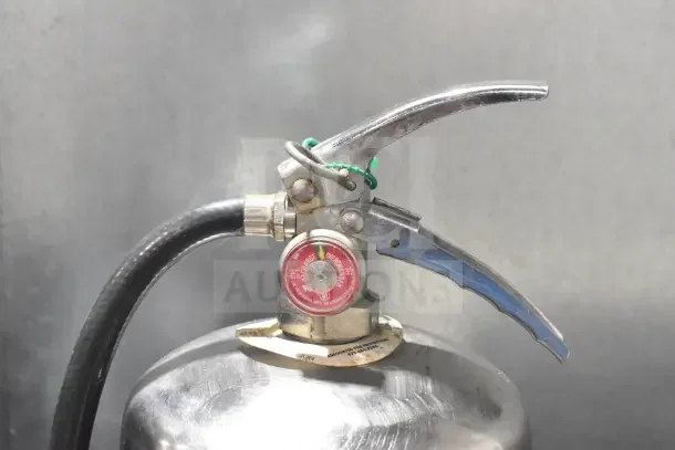 K Guard Wet Chemical Fire Extinguisher with red pressure gauge and hose, silver handle, buyer pickup only, visible label indicates inspection date.
