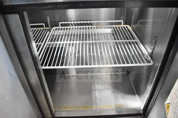 2018 Atosa MSF8304GR sandwich prep table, commercial casters, 115V, open stainless interior, wire shelving, minor wear.