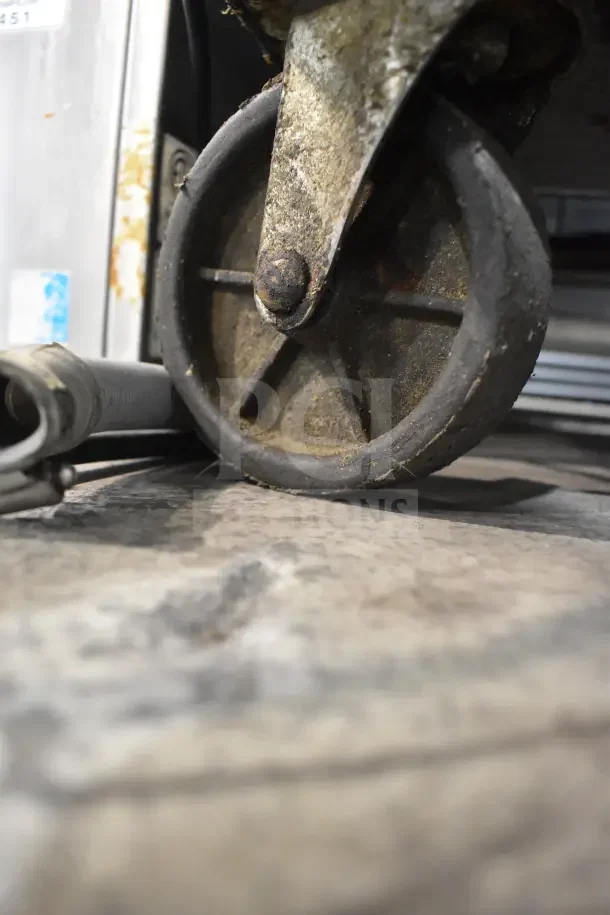 2018 Atosa MSF8304GR Prep Table wheel detail, showing wear. Commercial casters for mobility. 115V, 1 phase.
