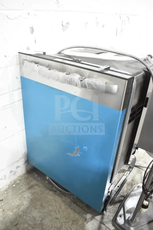 Frigidaire undercounter dishwasher with blue panel, 115 volts, 1 phase. Features protective plastic wrap, slight cosmetic wear.
