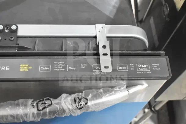 Frigidaire undercounter dishwasher control panel, showing cycle, temperature, dry, delay settings, and protective coating label.