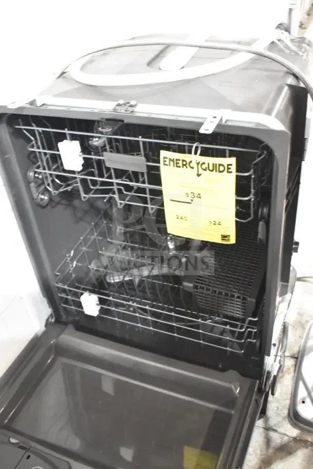 Frigidaire undercounter dishwasher, 115 volts, 1 phase. Open view showing racks and EnergyGuide label. Good condition.