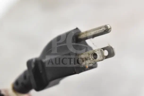 Close-up of a worn electrical plug, part of a Hatco Commercial Countertop Heated Holding Merchandiser. Signs of wear visible.
