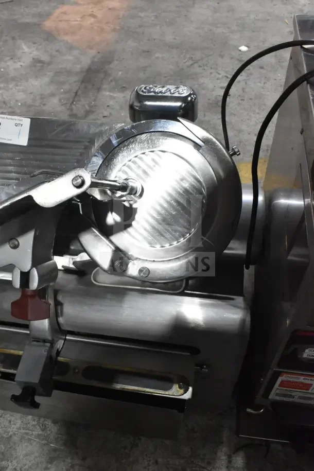 Globe 775L Commercial Meat Slicer, automatic, with blade sharpener, 115 volts, 1 phase, visible safety label.