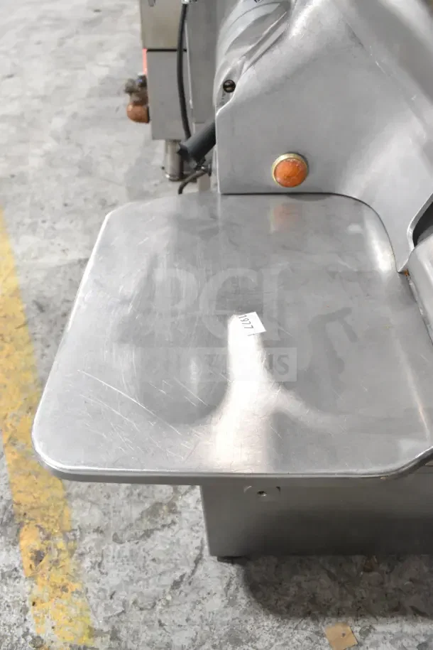 Globe 775L commercial automatic meat slicer with blade sharpener, shown on a countertop, 115V, 1 Phase, used condition.
