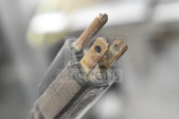 Close-up of a used power plug for a Bunn G9-2T DBC commercial coffee grinder, showing signs of wear.