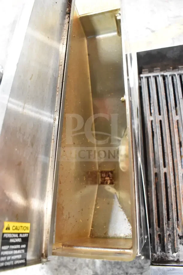 Bunn G9-2T DBC coffee grinder, stainless steel, open bean hopper view, visible caution label, used condition.