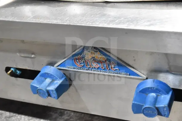 Prince Castle FHP48-2RB charbroiler with 4 burners, blue gas knobs, Comstock Castle logo, stainless steel body.