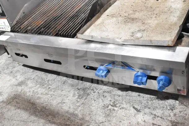 Prince Castle FHP48-2RB countertop natural gas charbroiler, 4 burners, stainless steel, visible wear, blue control knobs.