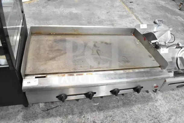 Wells Commercial Gas Flat Top Griddle, countertop model, stainless steel, used condition, three control knobs visible.