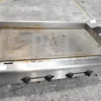 Wells Commercial Gas Flat Top Griddle, countertop model, stainless steel, used condition, three control knobs visible.