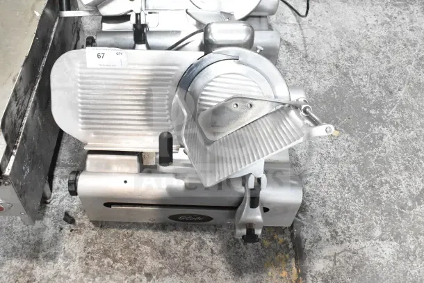 Globe 500L Commercial Countertop Meat Slicer, includes blade sharpener. 120V, used condition, visible model label.