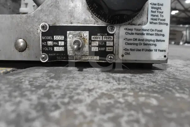 Globe 500L Commercial Meat Slicer, 120V, with blade sharpener, model plate details visible, shows usage wear.