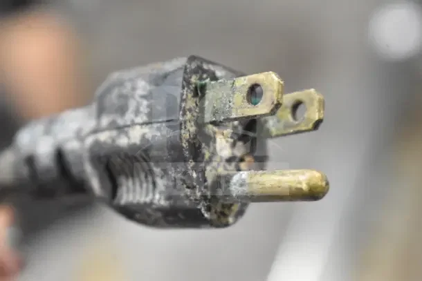 Corroded power plug of a Globe 500L Commercial Meat Slicer, indicating wear and potential electrical issues.