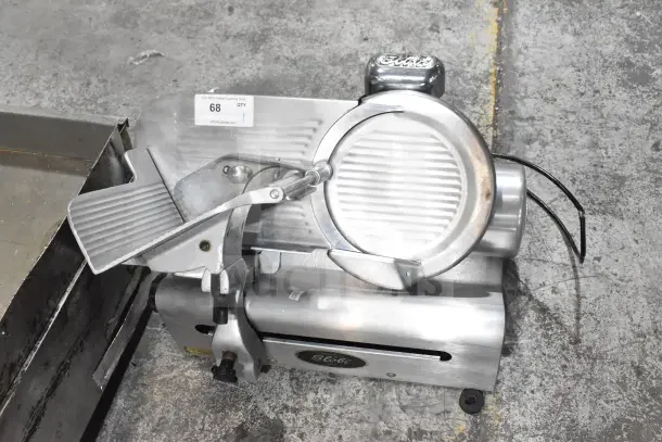 Globe 500 commercial meat slicer with blade sharpener, 115V, 1 phase, in good condition, includes product tray and Globe logo.