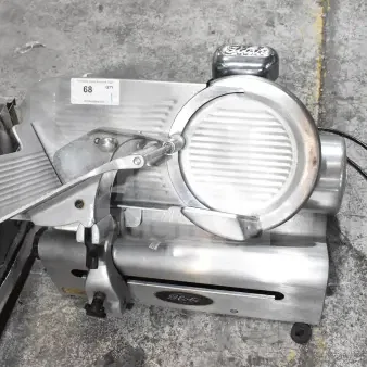 Globe 500 commercial meat slicer with blade sharpener, 115V, 1 phase, in good condition, includes product tray and Globe logo.