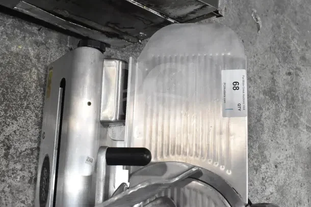 Globe 500 Commercial Meat Slicer with blade sharpener, 115V, 1 phase, shown in used condition. Auction tag reads "68 QTY".