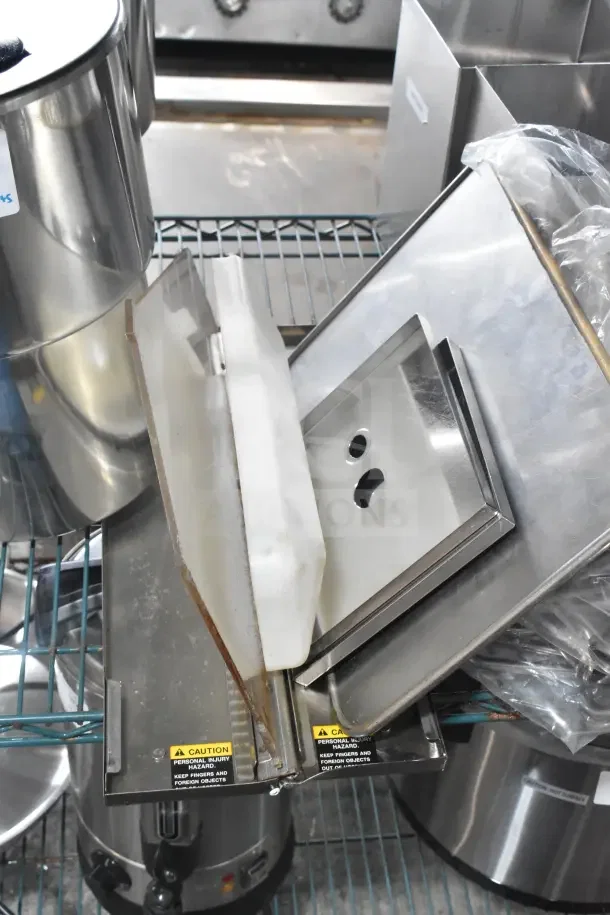13 various stainless steel items, including drop-in bins, Server CPSS-F lids, and pumps. Visible caution labels.