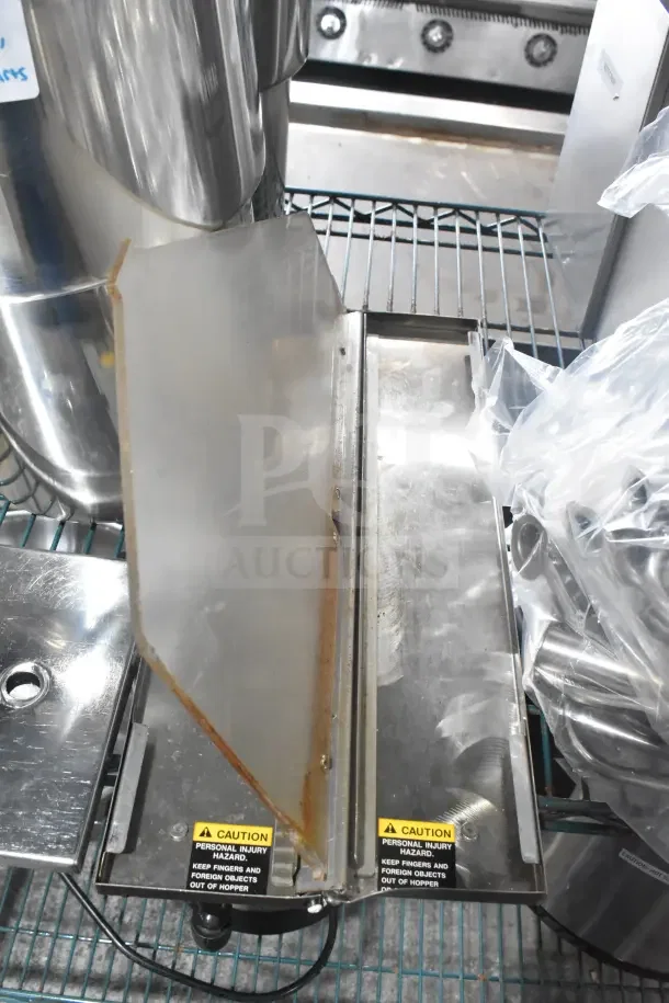 Metal storage and dispensing items, including drop-in bins, Server CPSS-F lids, and pumps, with caution labels, on a wire rack.