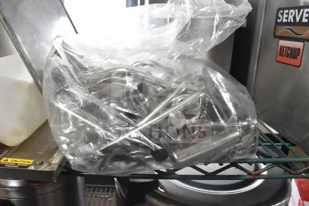 Lot of 13 items including drop-in bins, Server CPSS-F lids, and pumps in used condition in a plastic bag.