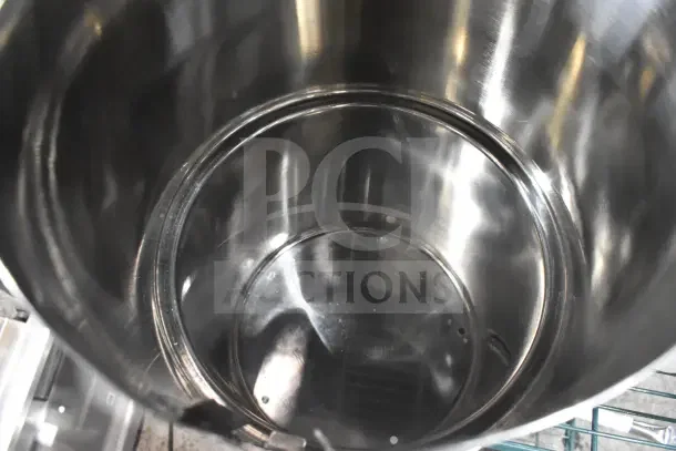Stainless steel pot interior, part of a set with condiment bottles and pumps. Shiny, well-maintained condition.
