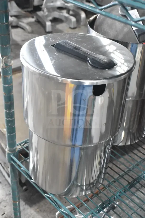 Stainless steel condiment dispenser with lid on wire rack. Durable, polished finish, ideal for commercial use.