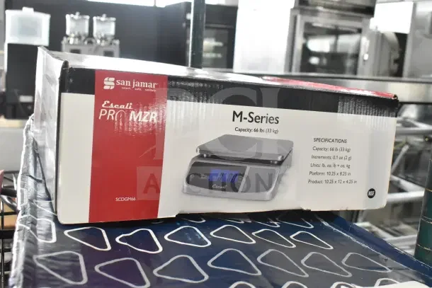 Brand new San Jamar Escali SCDGM66 66 lb. digital kitchen scale. Box shows item image and specs. Slight scratch visible.