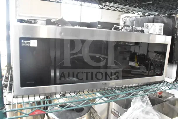 2025 Samsung ME11A7510DS microwave oven, stainless steel, 120V, 1 phase, with plate visible in warehouse setting.