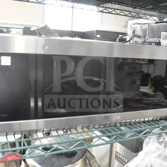 2025 Samsung ME11A7510DS microwave oven, stainless steel, 120V, 1 phase, with plate visible in warehouse setting.