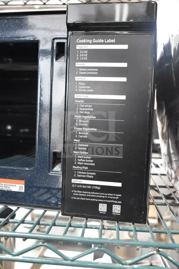 2025 Samsung ME11A7510DS Microwave Oven, 120V, with cooking guide label, stainless steel finish, includes plate.