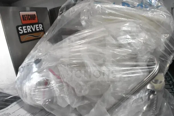 Bag of 7 server SS1 pump parts and various items. Includes stainless steel components. Ketchup server visible in background.