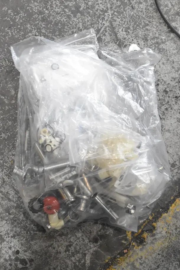 Bag of Server SS1 pump parts, mixed metal and plastic pieces, sealed in clear plastic. Sold as a lot of 7.
