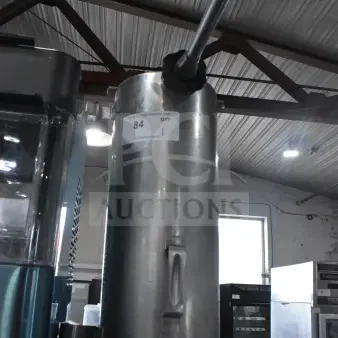 Vegetable chute with pusher for meat slicer, stainless steel, vertical design. Shows auction label number 84, good condition.