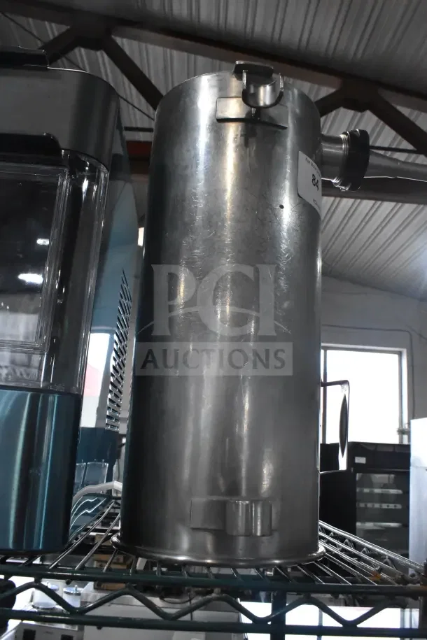 Stainless steel vegetable chute with pusher for meat slicer in good condition, ideal for efficient food processing.
