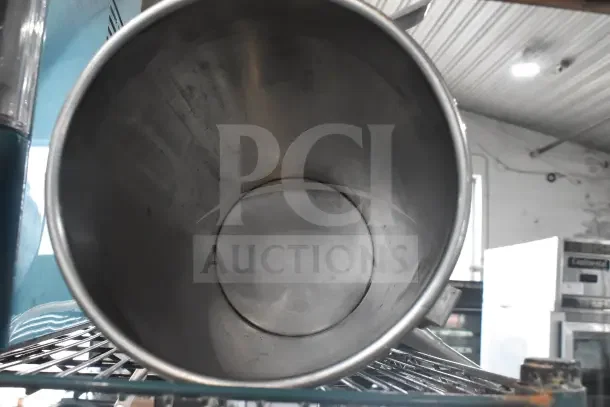 Vegetable chute with pusher for meat slicer, stainless steel, good condition, circular design, industrial kitchen setting.