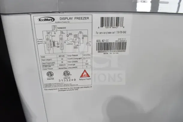 KoolMore MCF-20C commercial display freezer, 20 cu. ft., 115V, 1 phase. New, scratch and dent, model details visible.