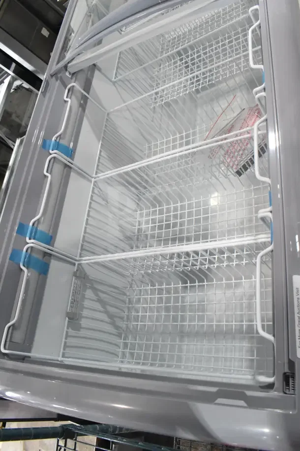 Brand new KoolMore MCF-20C ice cream display freezer, 20 cu. ft., 115V, scratch and dent, interior basket view.